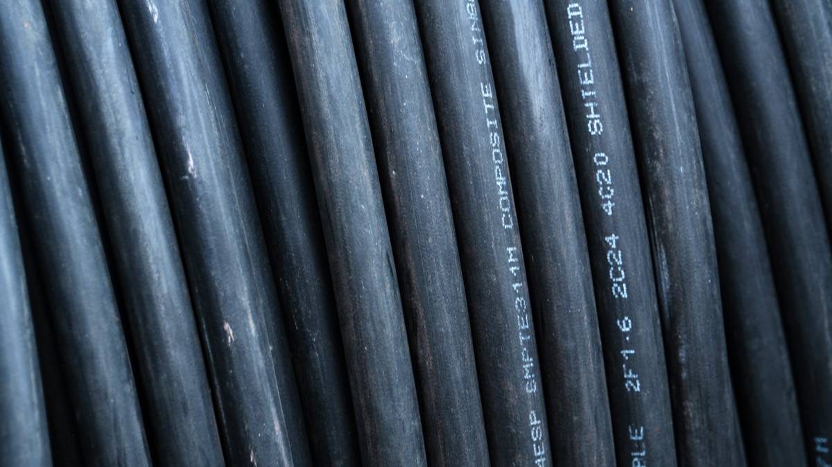 Close-up of labeled solar panel cables with documentation showing solar cable hs code
